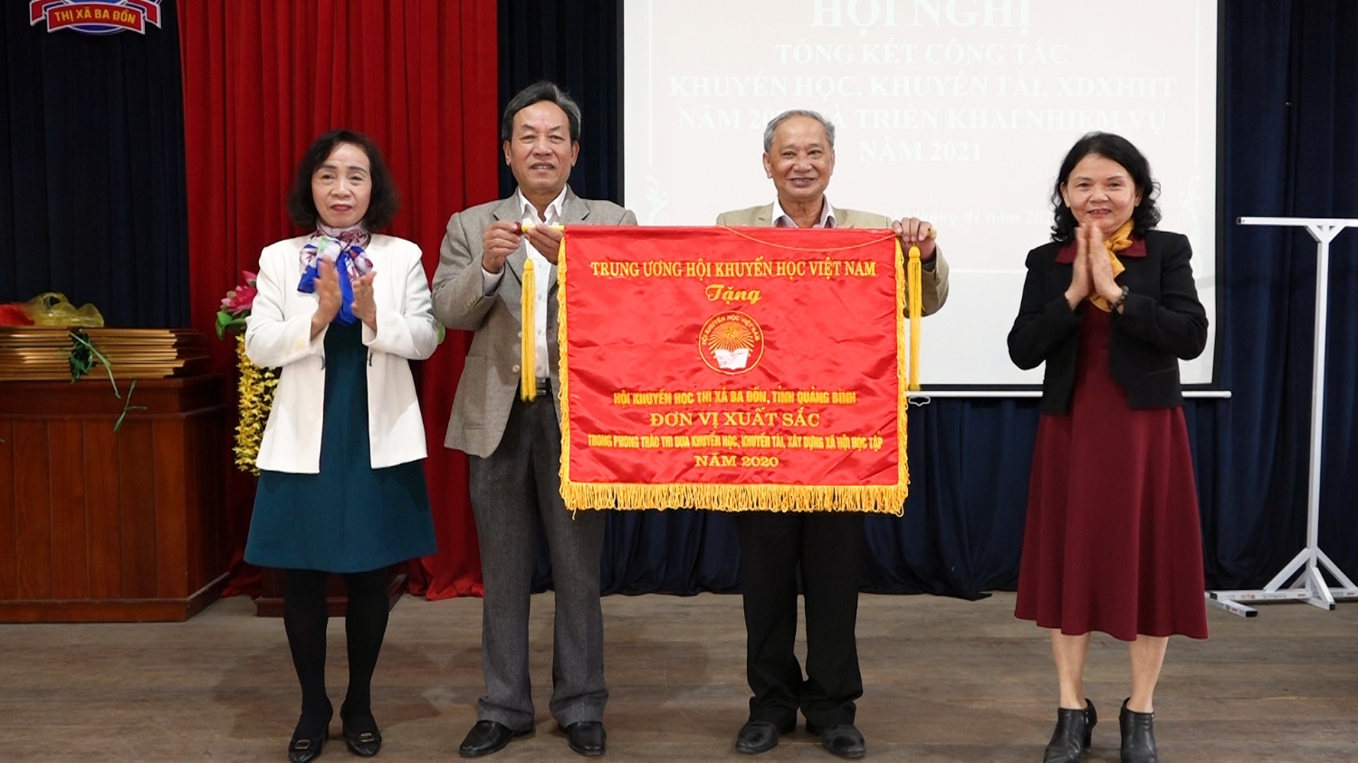 Bà Phạm Thị Bích Lựa- Chủ tịch Hội khuyến học tỉnh trao cờ thi đua của Trung ương hội khuyến học Việt Nam cho Hội khuyến học thị xã Ba Đồn.