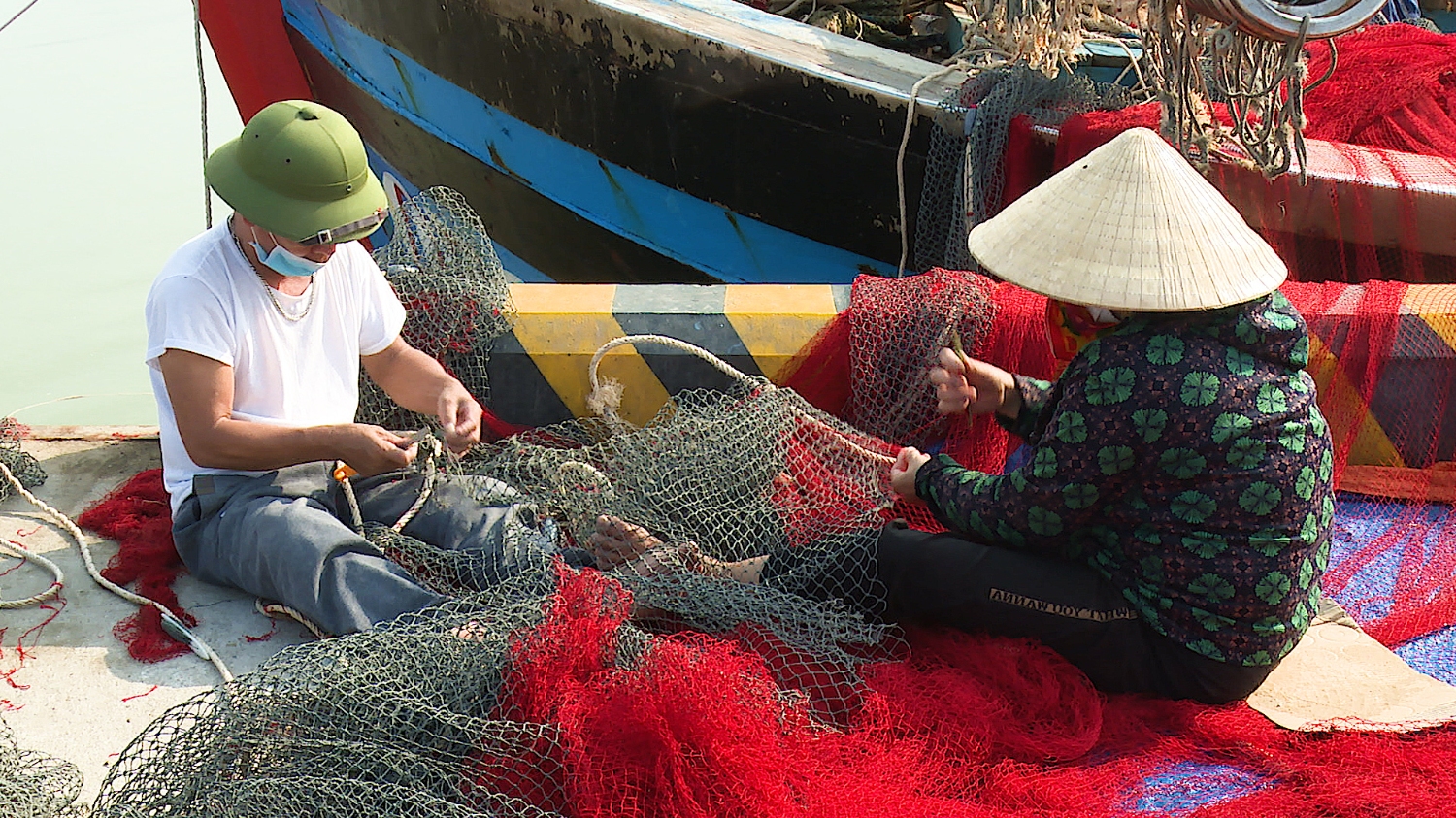 Người dân phường Quảng Phúc tỉ mẩn với công việc đan vá lưới